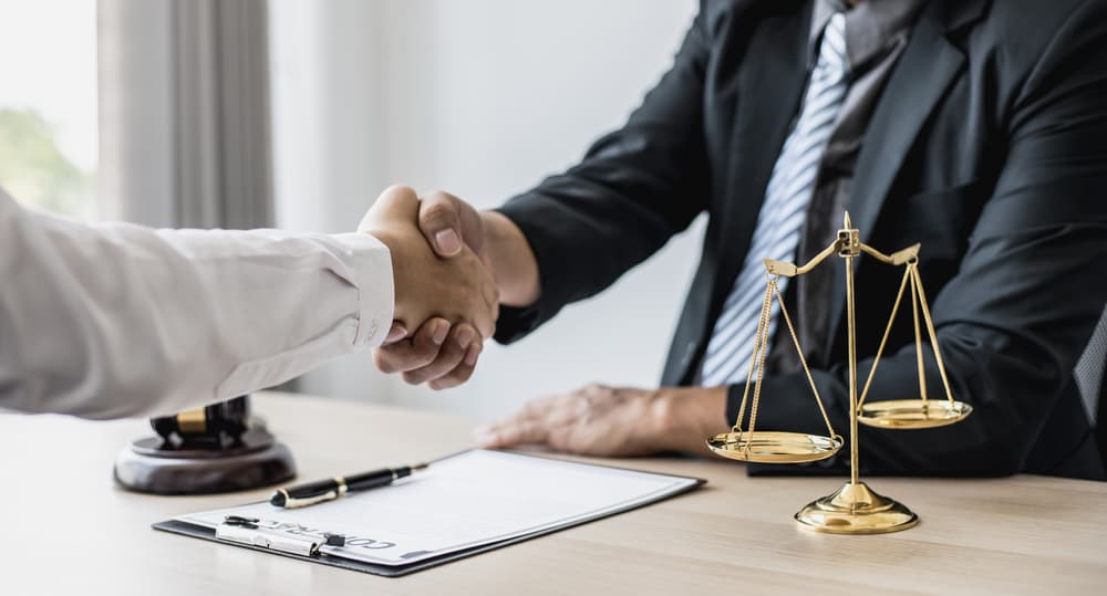 Lawyer and client shake hands